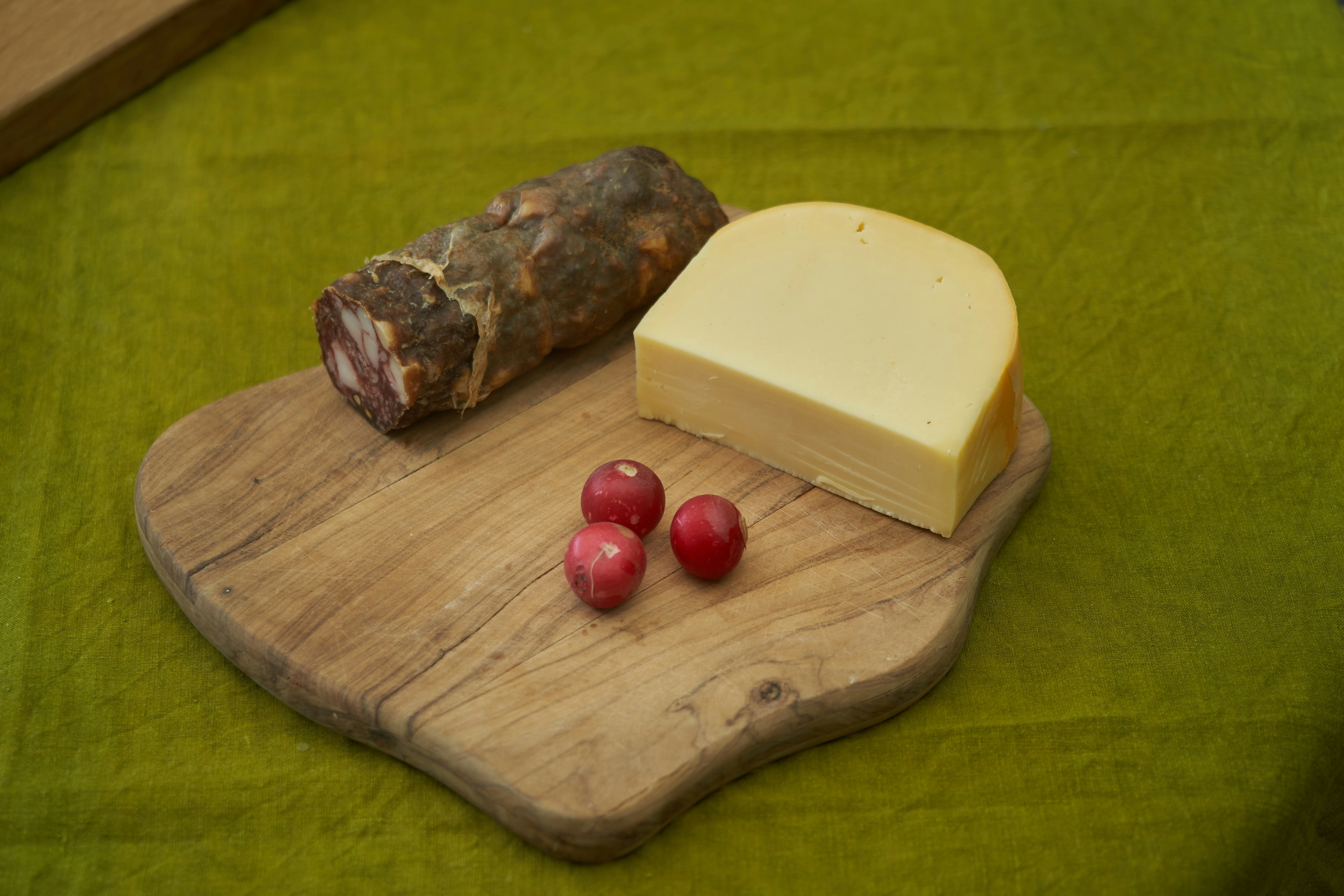 red round fruits on brown wooden chopping board